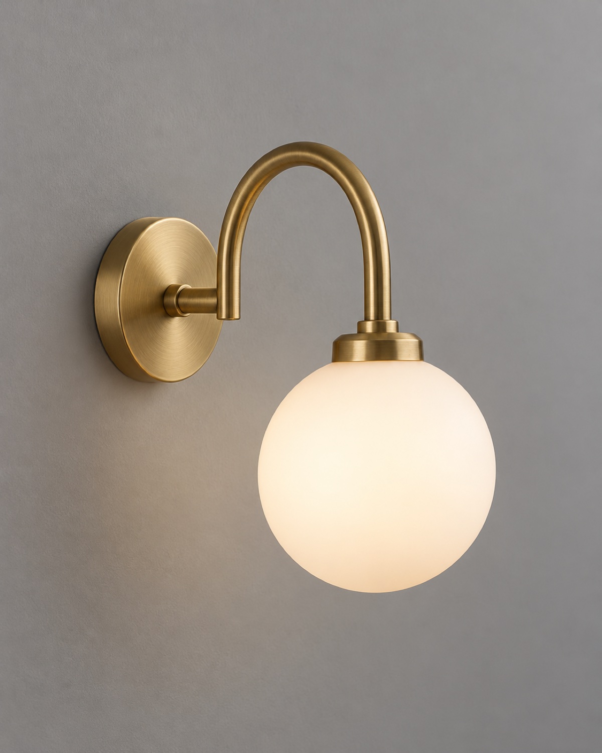 Brass wall sconce with a frosted globe